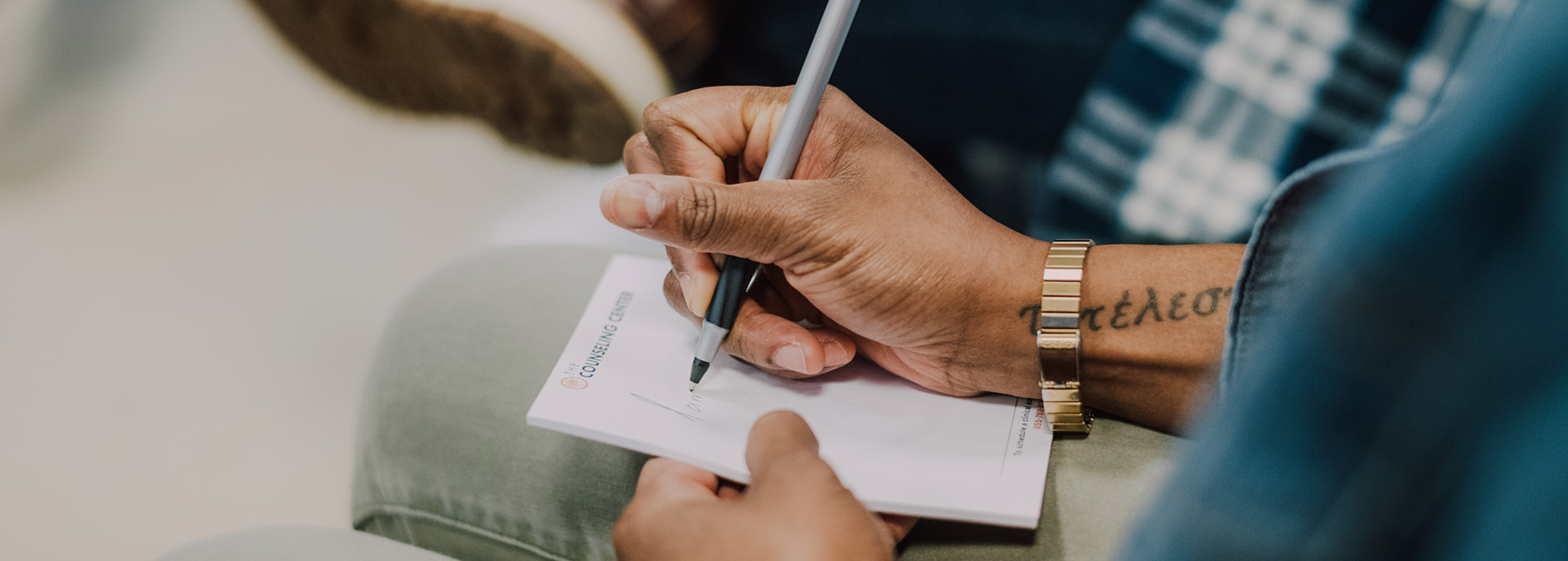 a man writing notes in a group session at West Caldwell