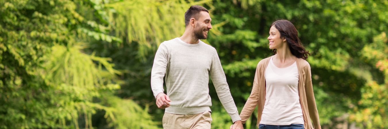 A couple walking hand in hand at a park during summer season enjoying life after rehab in West Caldwell